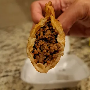 Inside the empanada filled with seasoned ground beef