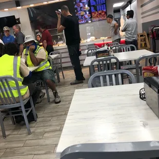 people sitting at tables in a restaurant