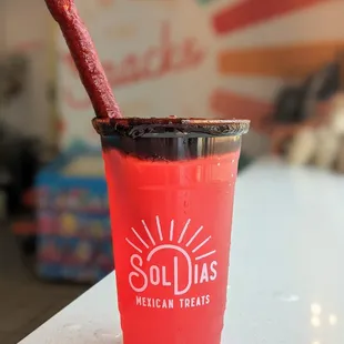 a red cup with a straw in it