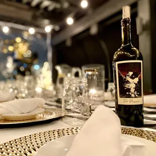 a table setting with a bottle of wine