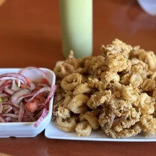 Chicharron de Calamar Salsa Criolla and the green sauce in the back