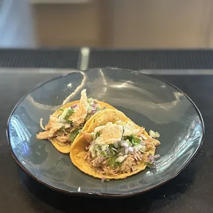 CARNITAS STREET TACOS (2): avocado, onion &amp; tomatillo salsa topped with chicharron | $8 (taco Tuesday)