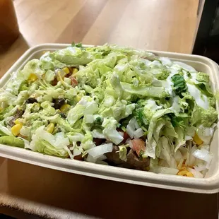 a salad in a styrofoam container