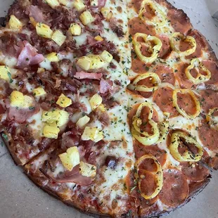 a pizza with pineapples and ham
