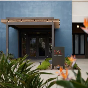 the entrance to a building with a sign in front of it