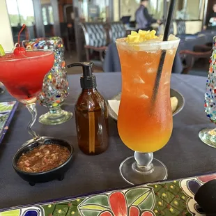 a table with drinks and condiments