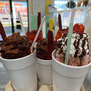 two cups of ice cream and strawberries