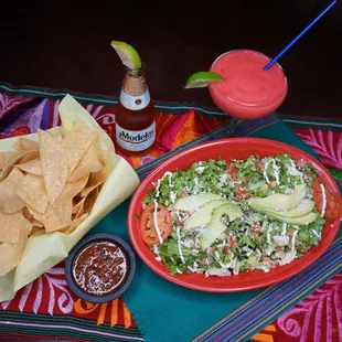 Salpicon Tostada paired with chips, salsa, your favorite beer, and a refreshing Strawberry Margarita.