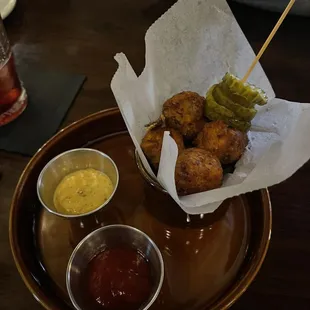 a basket of fried food and condiments