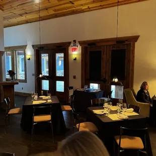 a woman sitting at a table in a restaurant