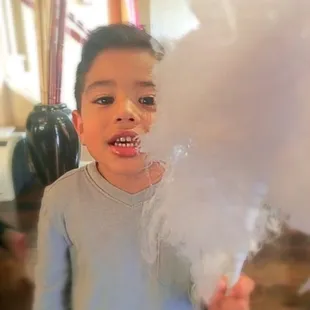 enjoying his cotton candy