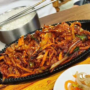 a plate of stir fried beef and vegetables