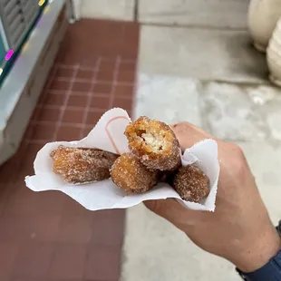 a hand holding a pastry