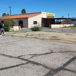 an empty parking lot with a building in the background