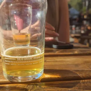 a glass of beer on a wooden table