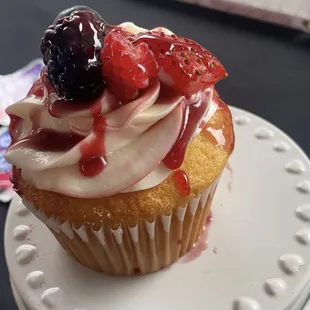 a cupcake with berries on top