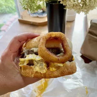 cheehead burger with an onion ring