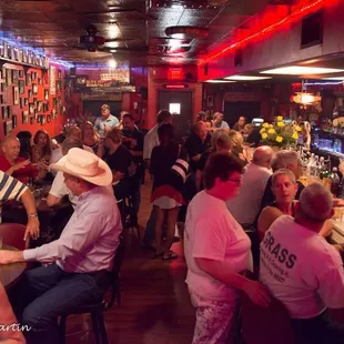 a large group of people sitting at a bar