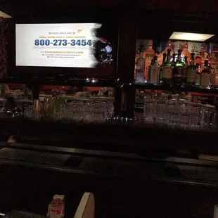 a bar with a large screen tv