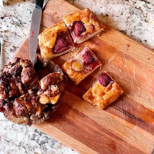 a cutting board with a pastry and a knife