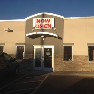 now open sign on building