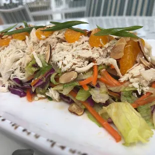 Chef Special Mandarin Salad: Iceberg Lettuce, Red Cabbage, Carrots, Orange Ginger Dressing, Shredded Chicken, Almonds, and Scallions.