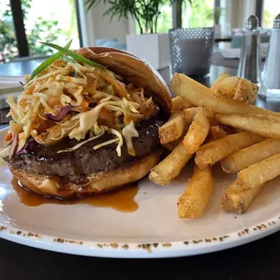 Chef Special Korean BBQ Burger: 1/2 Pound Angus Steak,House Made BBQ Sauce, Kimchi Slaw on a Challah Bun &amp; served with a side of Fries.