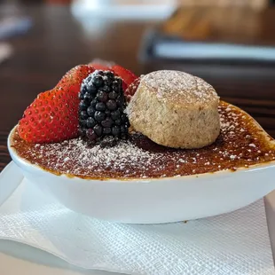 a dessert with berries and powdered sugar