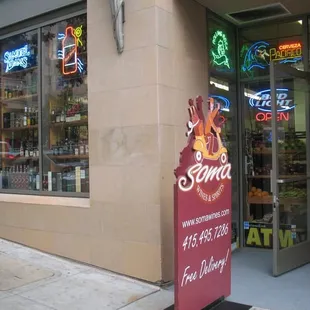 storefront with neon signs
