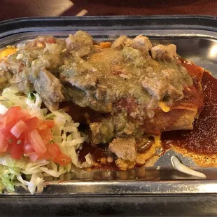 Single tamale with chile verde on top of the red sauce