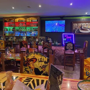 a restaurant with neon signs