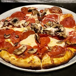 Personal pizza with pepperoni and mushrooms