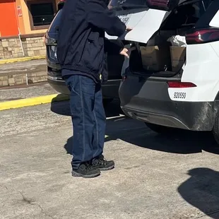 a man opening the trunk of a car