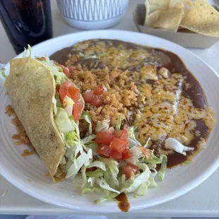 The number one combo - a cheese enchilada and a beef taco with beans and rice