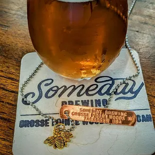 a glass of beer on a coaster