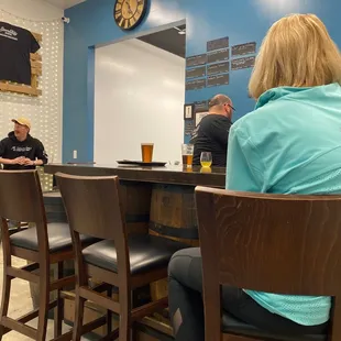 a group of people sitting at a bar