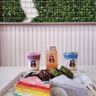 front: rainbow (3/5) + taro (5/5) crepe cakes center: cookies (2/5) back: ocean latte (3/5) and lychee tea drinks