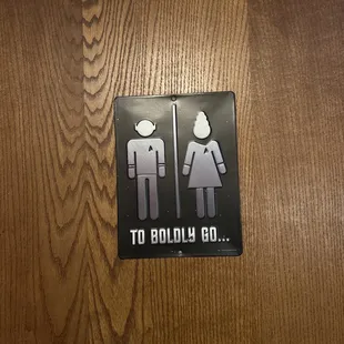 a bathroom sign with a man and a woman on it