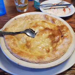 a pie on a plate with a fork