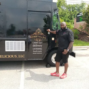 a man standing in front of a food truck