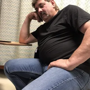 a fat man sitting on a chair