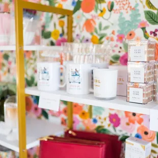 a shelf of candles and books
