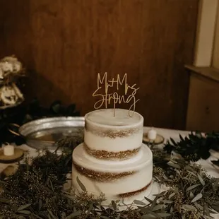 a three tiered cake with a happy birthday topper