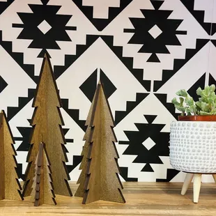 three wooden christmas trees on a table