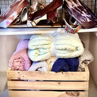 a wooden crate filled with blankets