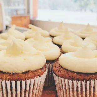 a plate of cupcakes with frosting
