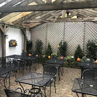 a patio with tables and chairs