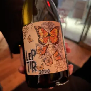 a person holding a bottle of wine