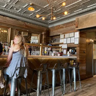 a woman sitting at a bar