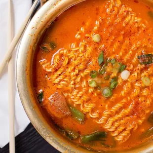 BUDAE JJIGAE Spicy sausage stew w/ spam, ham, sausage, ground beef, tofu, and ramen noodles. Served with rice.